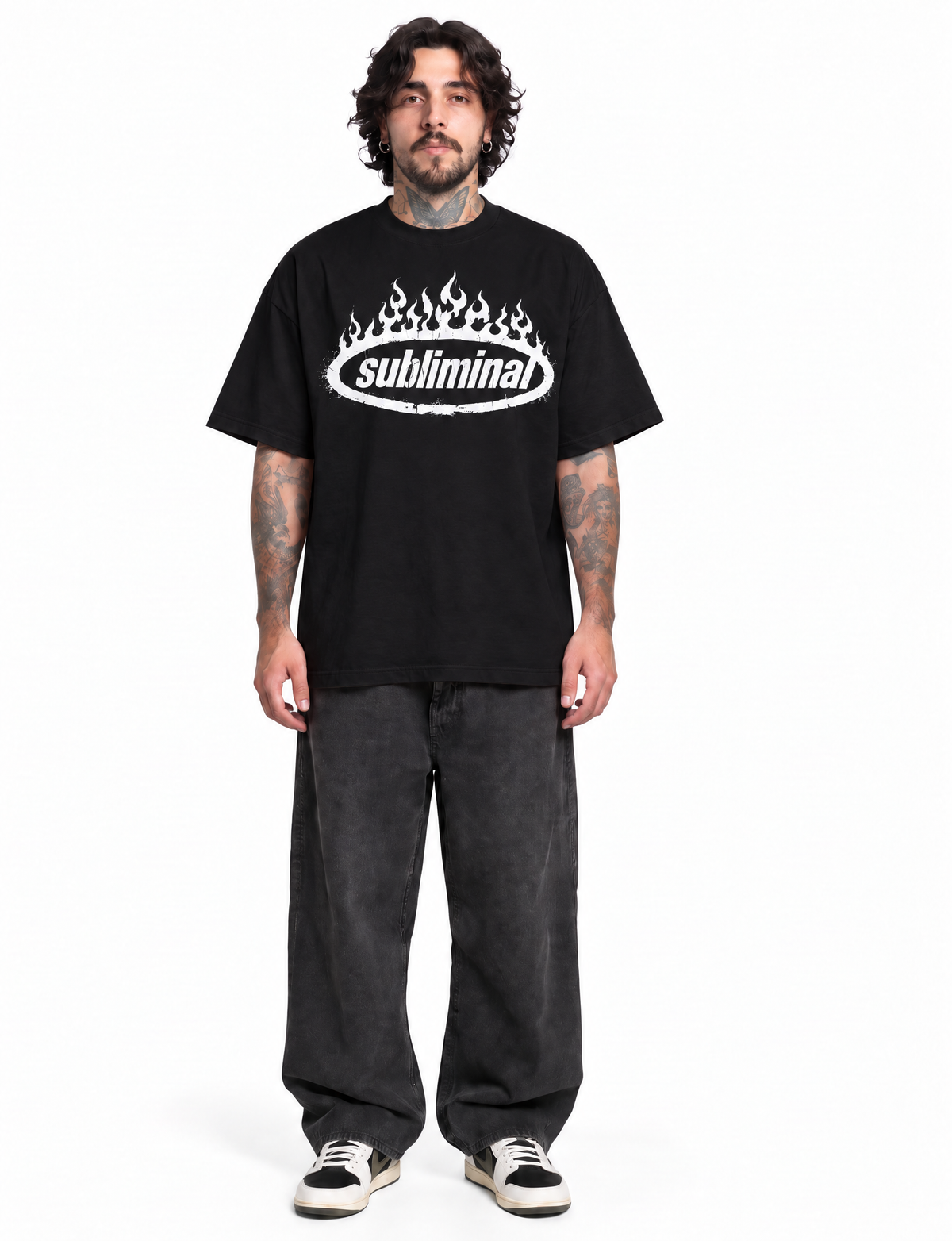 Black — SUBLIMINAL Tee, front view on model showing the oversized fit and white flame graphic