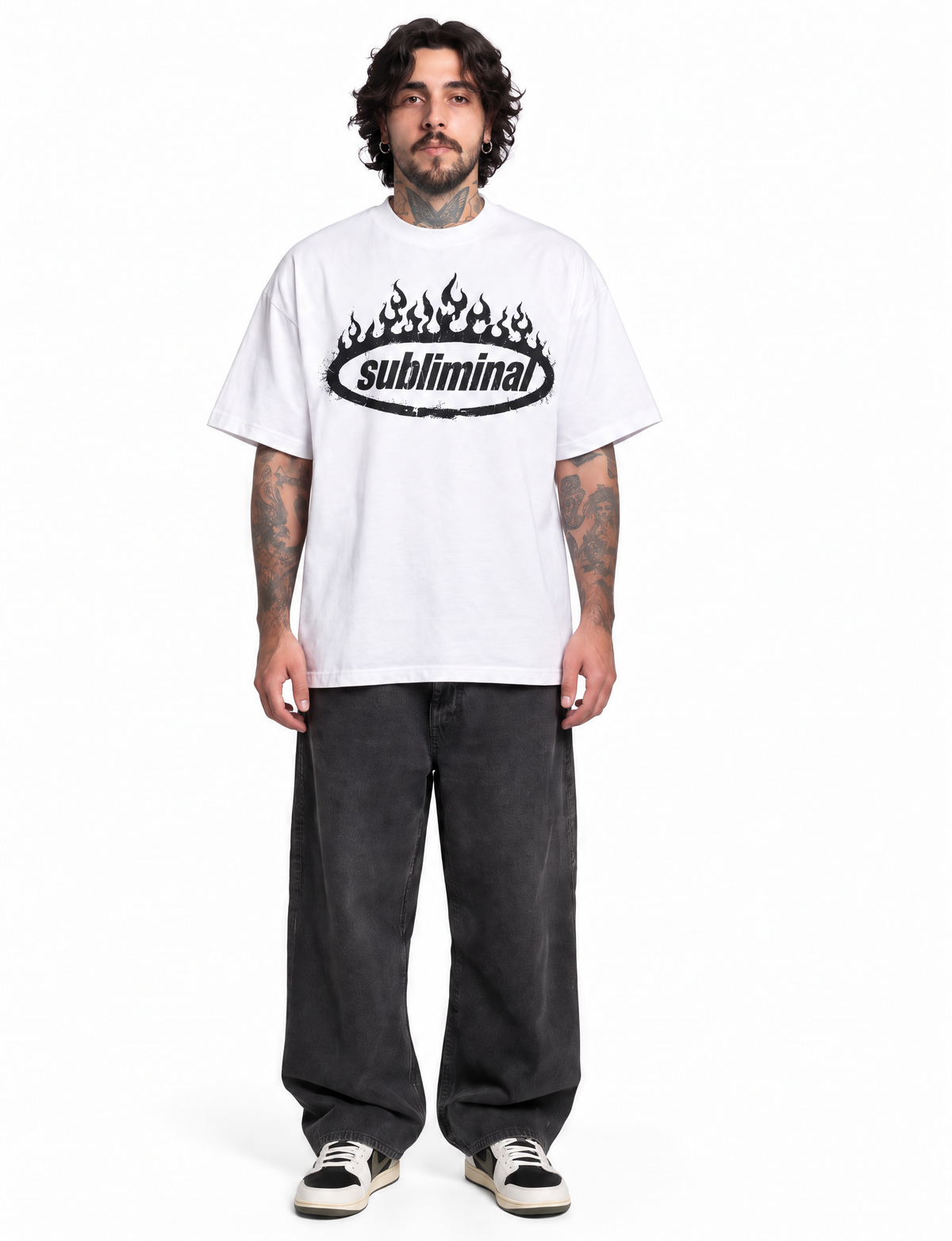 White — SUBLIMINAL Tee, front view on model showing the oversized fit and black flame graphic