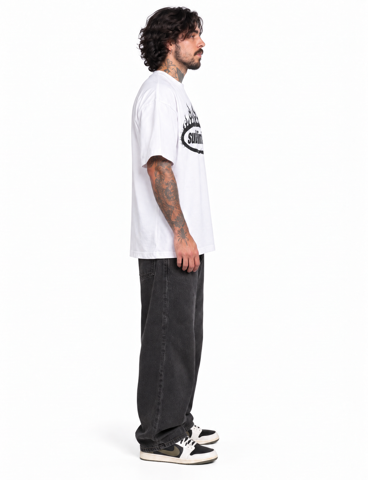 White — SUBLIMINAL Tee, side view on model showing sleeve length and the oversized silhouette