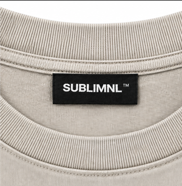Tan / White Print — SUBLIMINAL Distressed Tee, neck tag detail